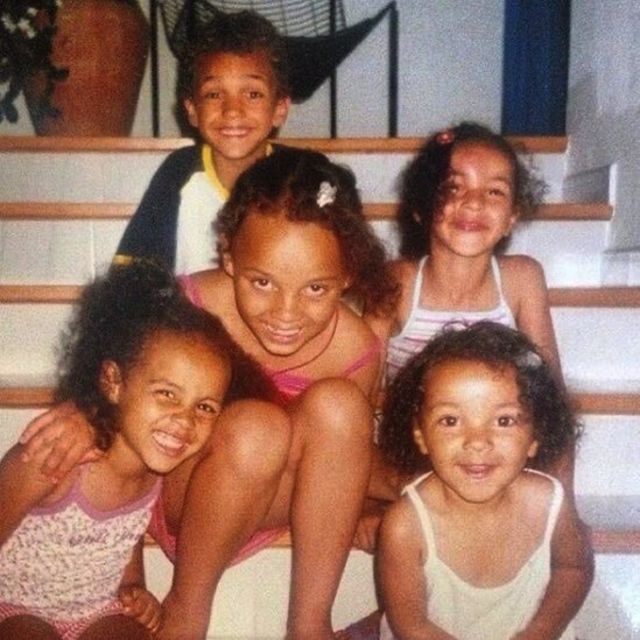 Alexandra with her siblings, sitting on the stairs
