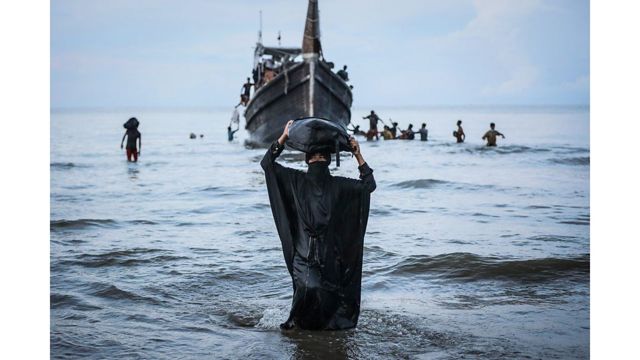 Refugiada rohingya camina en el mar hasta la orilla en Indonesia 
