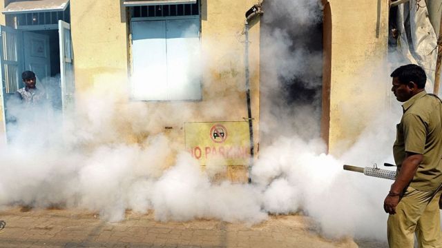 ஜிகா வைரஸ் தடுப்பு நடவடிக்கையாக ஒரு குடியிருப்புப் பகுதியில் புகை அடிக்கும் உள்ளாட்சி ஊழியர்.