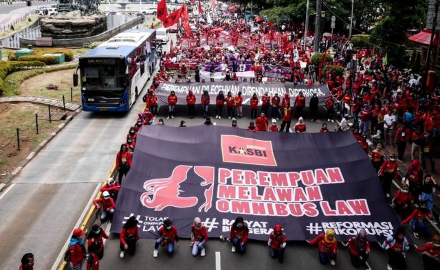 Women carry posters at a march for International Women's Day in Jakarta, 8 March 2020