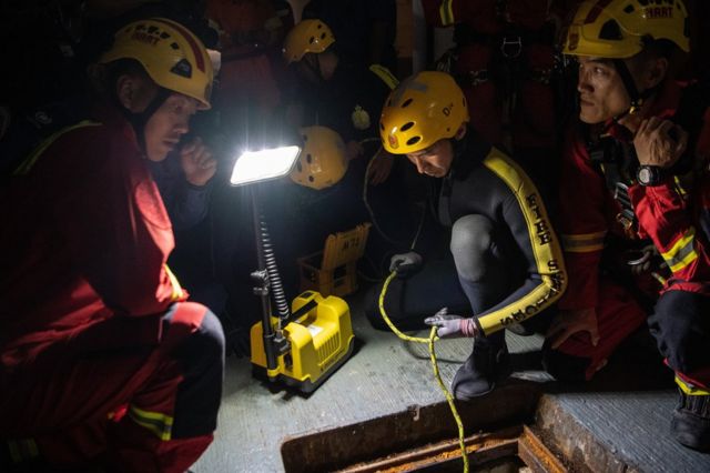 Fire service department personnel inspect a sewer after receiving a report that anti-government protesters had attempted to escape Hong Kong Polytechnic University through the sewage system on November 19, 2019 in Hong Kong, China