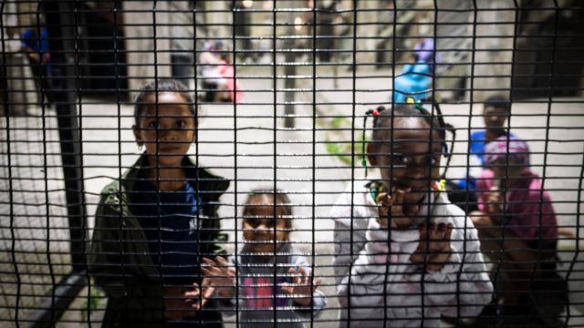 Children near a fence in Mannenburg, Cape Town - South Africa