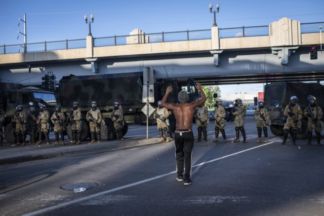 10. A demonstrator holds his hands up in front of a line of Minnesota National Guardsmen during protests resulting from the killing of an unarmed black man, George Floyd, by police