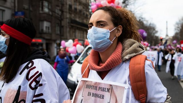 Public hospital workers and medical workers are seen protesting in the streets of Paris, France