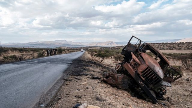 A damaged military vehicle lies on the side of the road north of Mekelle, the capital of Tigray on February 26, 2021