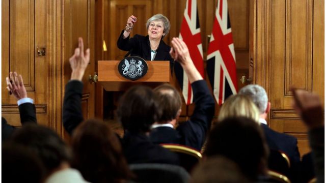 Theresa May pointing to journalists