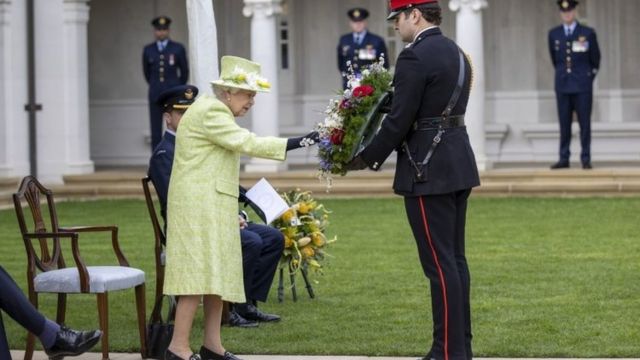 Queen Elizabeth II inspects a wreath during a service to mark the Centenary of the Royal Australian Air Force