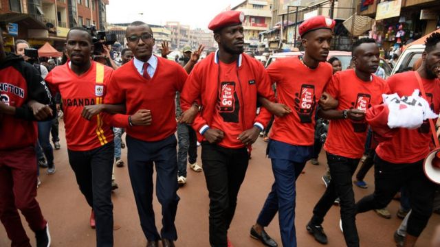 Musician turned politician Robert Kyagulanyi (C) is joined by other activists in Kampala on July 11, 2018 in Kampala during a demonstration to protest a controversial tax on the use of social media.
