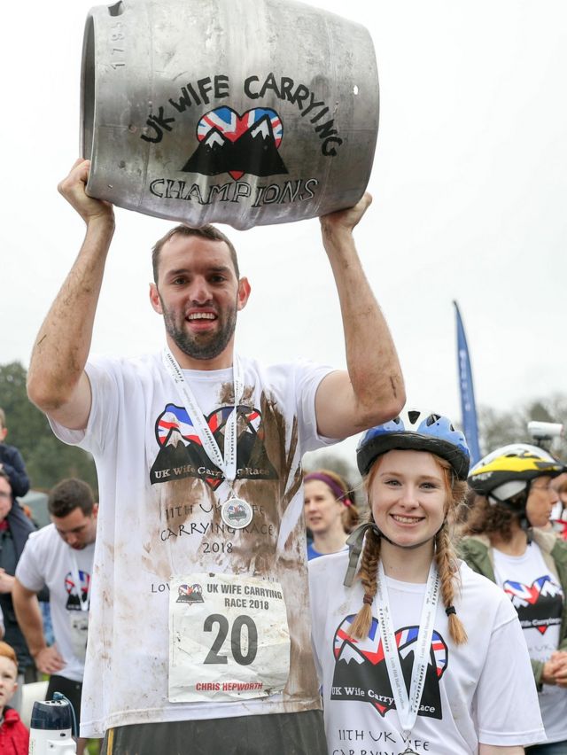 Chris Hepworth (left) with Tanisha Prince after winning the 11th UK Wife Carrying Race in Dorking, Surrey