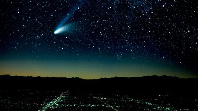 Hale-Bopp Comet And City At Night (Composite). (Photo by Education Images/Universal Images Group via Getty Images)