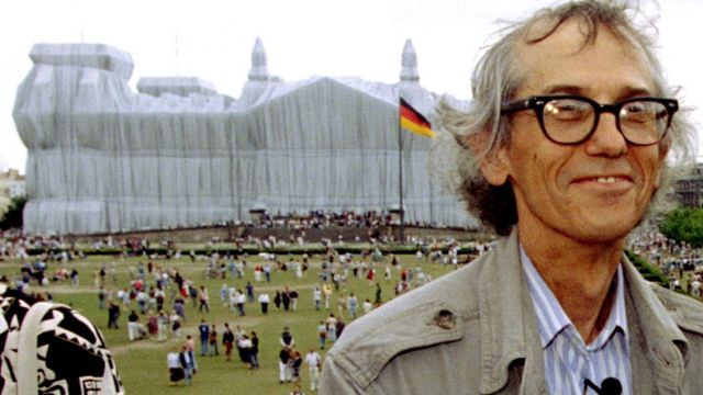 Conceptual artist Christo poses for photographers in front of the wrapped Reichstag, 26 June 1995