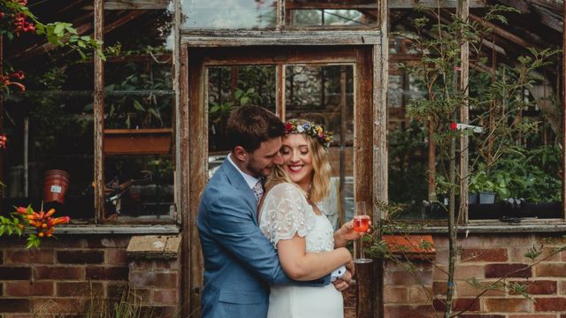 Married couple smile and hug for wedding photo