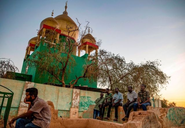 Sudanese Sufi Muslims gather outside the Hamad al-Nile shrine in Omdurman, the capital Khartoum's twin city, on January 15, 2021, for their weekly meeting after the Friday prayer, highlighted with poetry, mystical chants and dance.