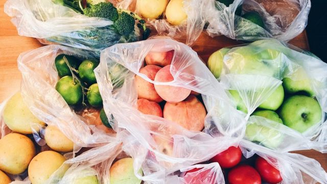 Fruit and vegetables in plastic carrier bags