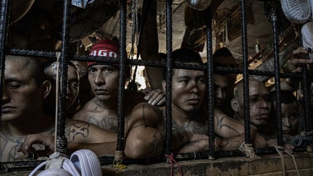 Inmates look out of an overcrowded cell in the Penal Center of Quezaltepeque, El Salvador. 9 November, 2018