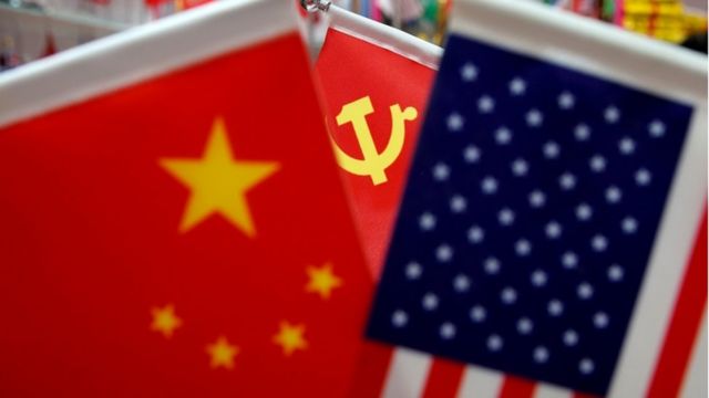 Chinese and US national flags and Chinese Communist Party flag
