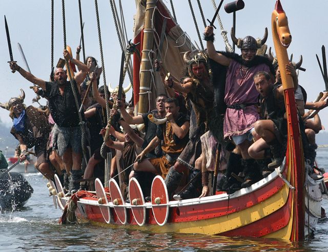 The people of the town of Catoira, in Galicia, northwestern Spain, on August 5, 2007 simulate the assault of Scandinavian warriors, in Viking attire with a replica of a Viking ship off the coast of Galicia 1000 years ago.