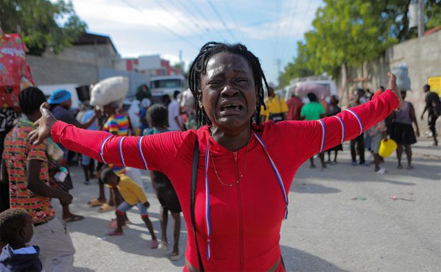 Woman cries as people are displaced by gang violence, Cite Soleil, Port-au-Prince, 19 November, 2022