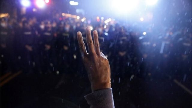 A protestor shows the three-finger salute during anti-government protests, in Bangkok, Thailand October 16, 2020.