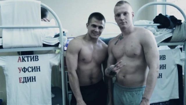Tulinov posando para foto ao lado de outro homem em quarto da prisão