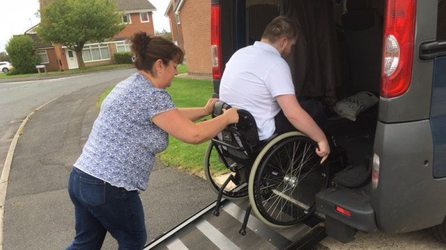 Christine loading her son Chris into their modified van.