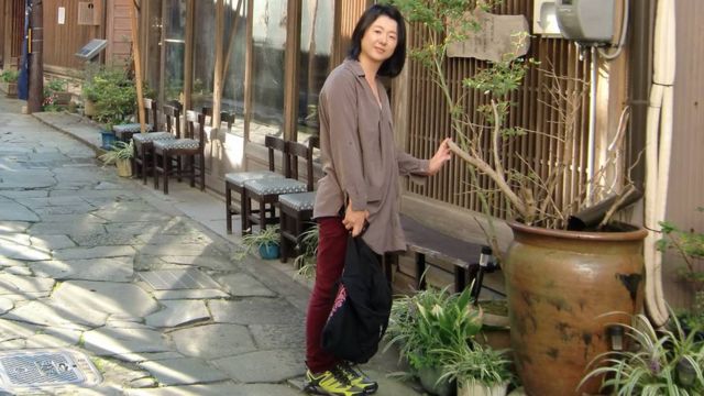 Eriko Kobayashi poses for a picture on a Japanese street