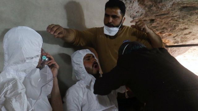 A man breathes through an oxygen mask in Khan Sheikhoun