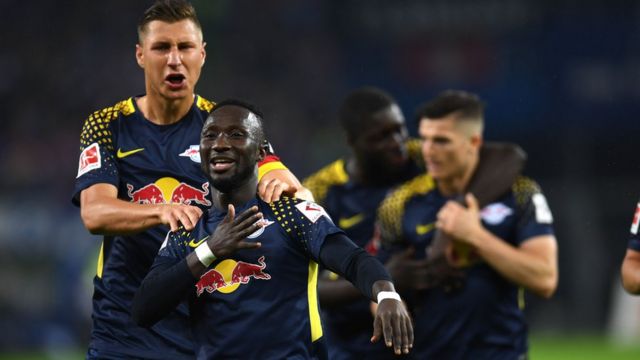Leipzig"s Guinean midfielder Naby Keita and his teammates celebrates after scoring during German first division Bundesliga football match between Hamburger SV and RB Leipzig in Hamburg on September 8, 2017.