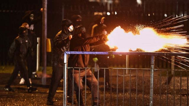 youths fire fireworks at the PSNI on the Springfield road, during further unrest in Belfast.