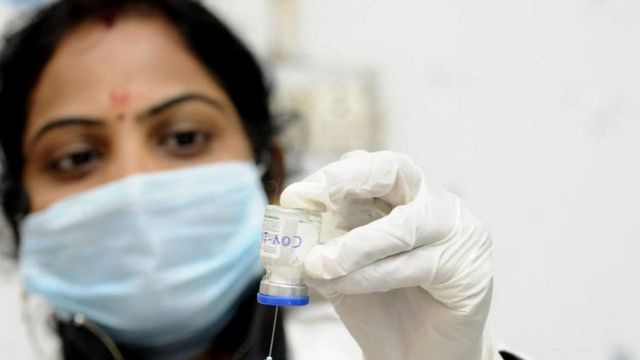 A health worker with vaccine during a trial run in Noida.