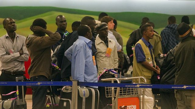 About 150 refugees are queuing up as they are being returned to Sudan from Ben Gurion Airport near Tel Aviv on December 13, 2010.