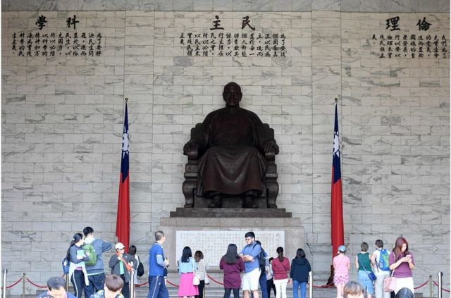 游客在台湾已故总统蒋介石的雕像前参观。