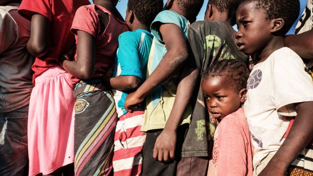 Niños esperando en fila para recibir ayuda de alimentos en Mozambique tras el ciclón Idai