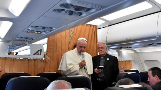 Pope Francis, flanked by Vatican spokesman Federico Lombardi, talks to journalists on flight back to Vatican, at end of three-day visit to Armenia, Sunday, June 26