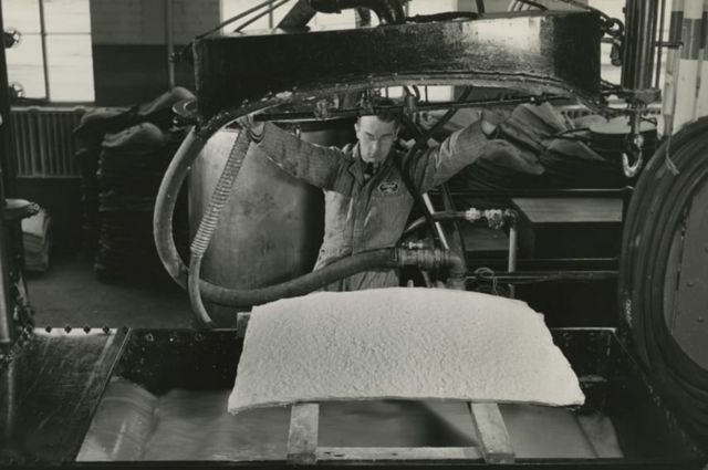 An employee of the Ford Company makes a part of a car made of bioplastic