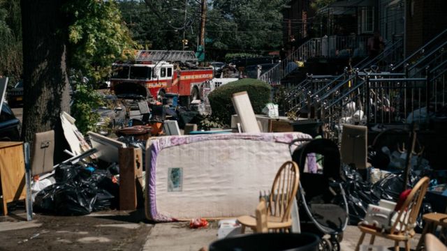 Residents sort through damaged and destroyed items after a night of heavy rain and wind caused many homes to flood on September 2, 2021 in the Flushing neighbourhood