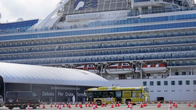 A bus is parked outside the Diamond Princess cruise ship docked at the Daikoku Pier Cruise Terminal in Yokohama, south of Tokyo, Japan, 19 February 2020