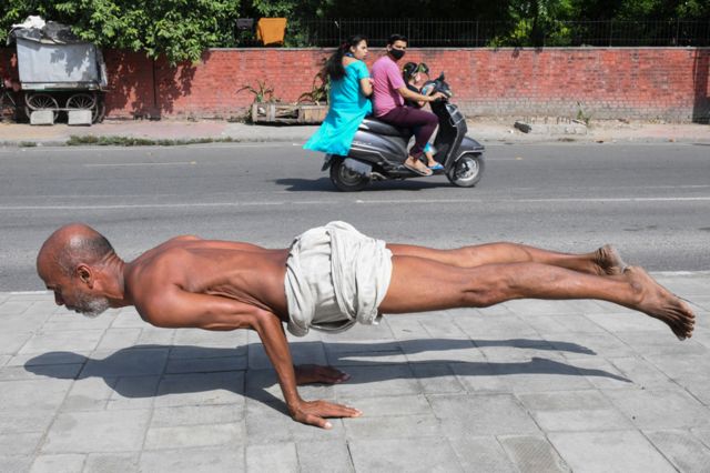 A man practises yoga on a street in Amritsar, India, on 6 October 2021