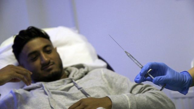 Needle used during procedure, with Abdul in background