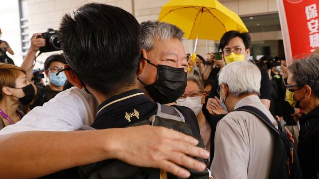 Pro-democracy activist Lee Cheuk-yan hugs a supporter as he arrives at West Kowloon court to obtain verdicts in a landmark illegal gathering case, in Hong Kong, China, on April 1, 2021. REUTERS / Tyrone Yeah