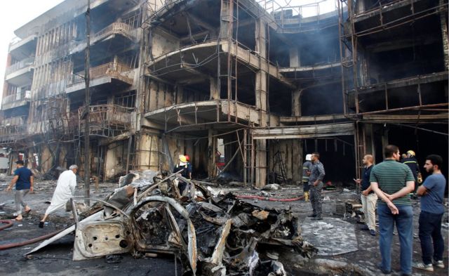 People gather at the site of a suicide car bomb in the Karrada shopping area, in Baghdad, Iraq July 3, 2016
