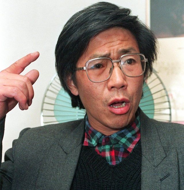Chinese dissident Qin Yongmin gestures during a press conference in Beijing on 17 November, 1993