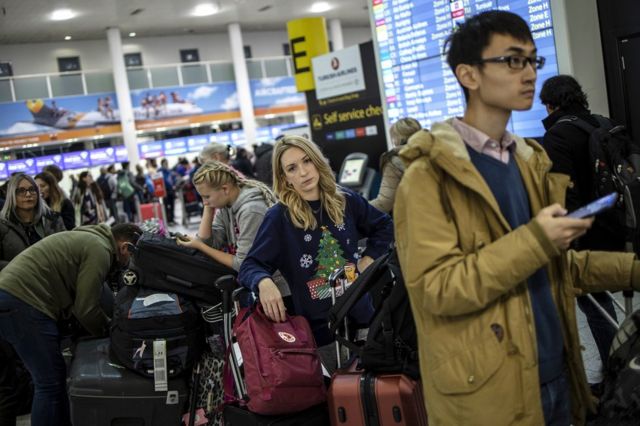 Passengers queue while waiting for announcements at Gatwick South Terminal on 20 December 2018