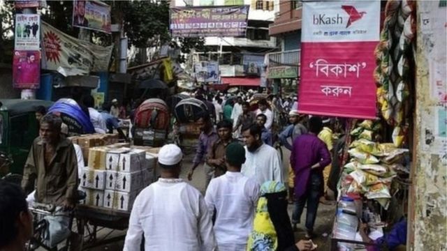 রাস্তার মোড়ে মোড়ে এরকম বহু জায়গায় চলছে টাকা-পয়সা পাঠানোর জমজমাট মোবাইল ব্যাংকিং