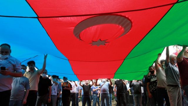 People carrying a huge flag of Azerbaijan