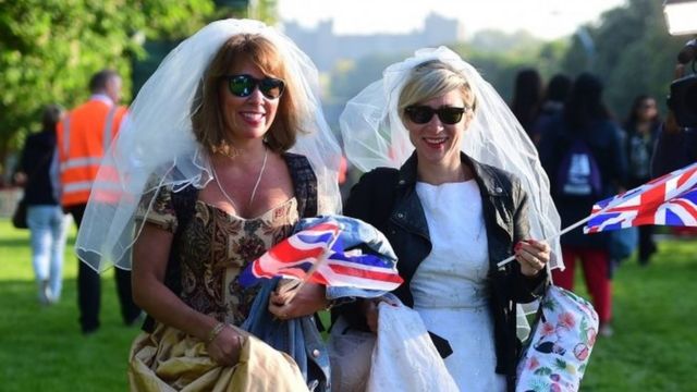 Women wear wedding dresses on the Long Walk