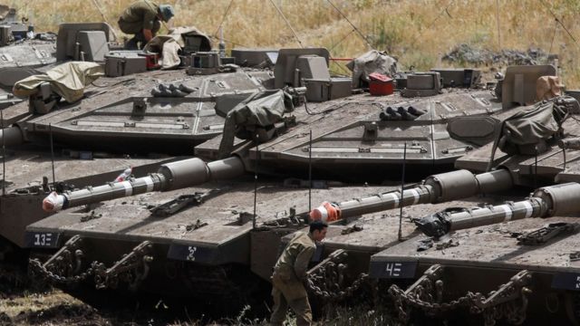 Israeli Merkava tanks and soldiers near the Syrian border in the Israel-annexed Golan Heights