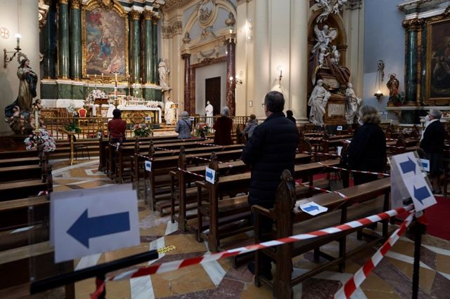 People attend mass in a church