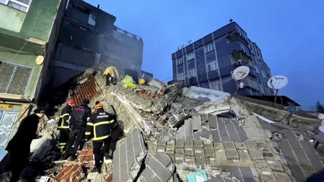 Rescuers search the rubble
