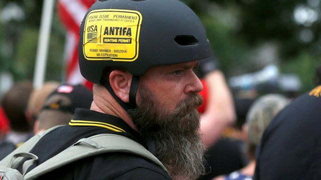 A man wears a sticker that says "Antifa Hunting Permit" at a Proud Boys rally in Portland, Oregon, U.S., August 17, 2019.